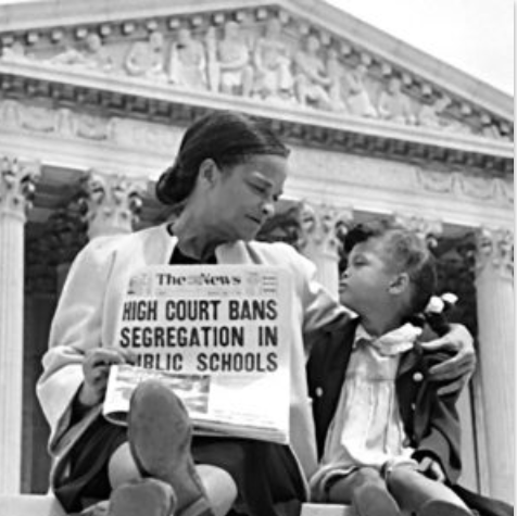 Woman & daughter sitting on Supreme Court steps holding up a newspaper calling for the end of school segregation