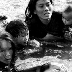 Refugees from the Vietnam War struggling in the water to reach safety.