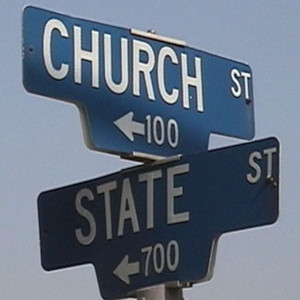 Two typical street signs appear one atop the other at an intersection reading “Church Street” and “State Street.”