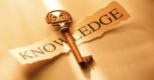 Skeleton key laying on top of a peice of paper that says knowledge