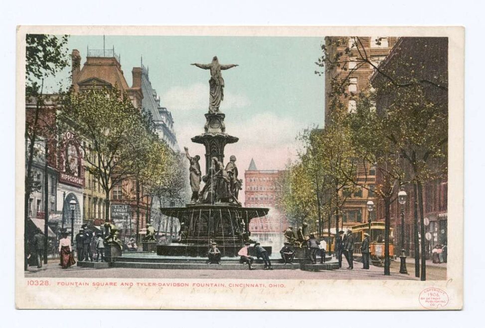 postcard of a tall fountain in a city square