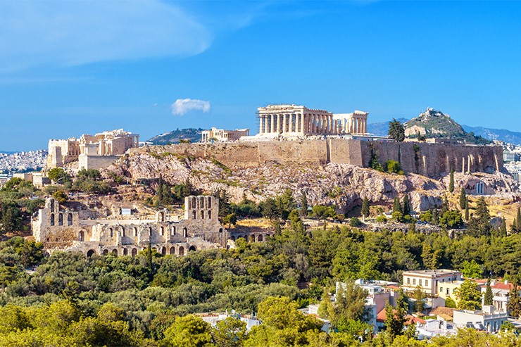 Color photograph depicts the Athenian acropolis on a sunny day.